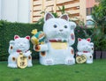 Giant white Japanese lucky cat sculpture in a group of three family cat at gateway Ekamai shopping mall.